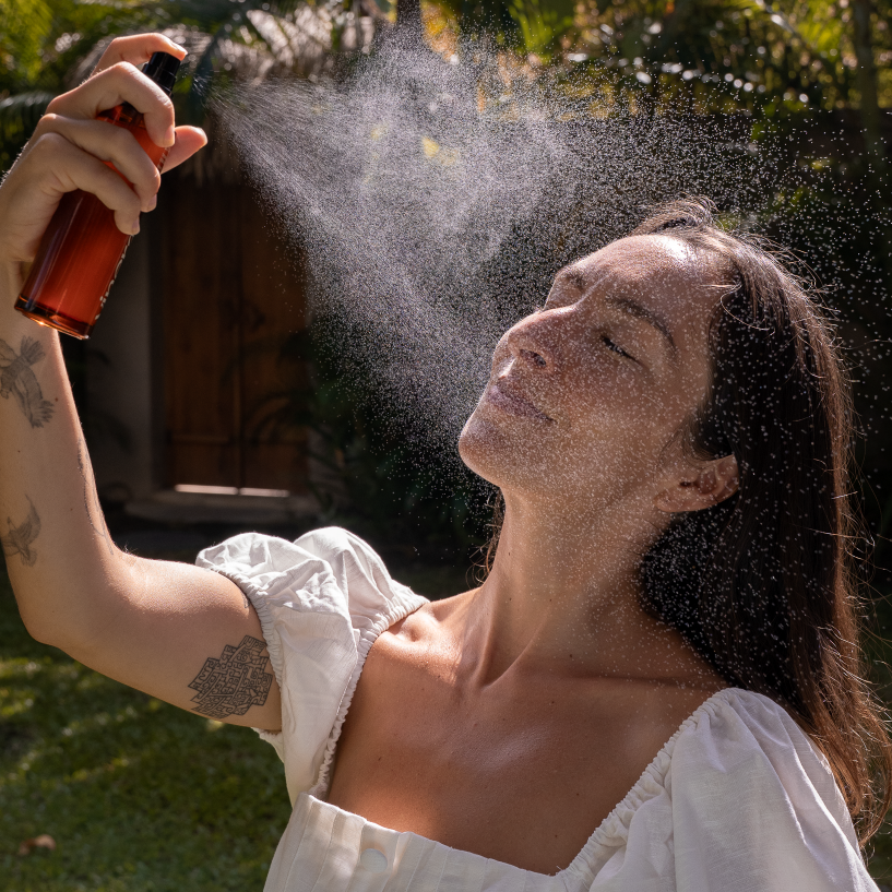 Spraying mist on face water droplets yinera skincare botanical mist