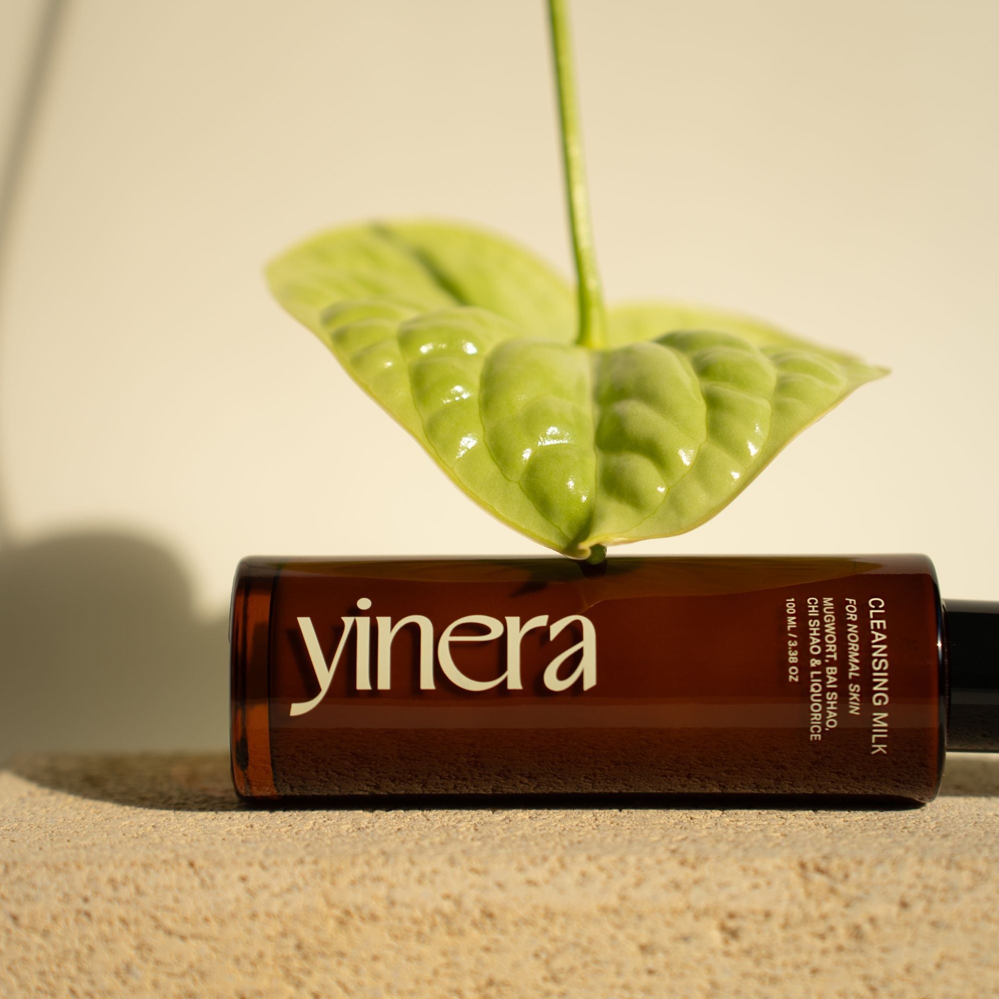 cleansing milk | yinera tallow skincare | amber bottle with green leaf