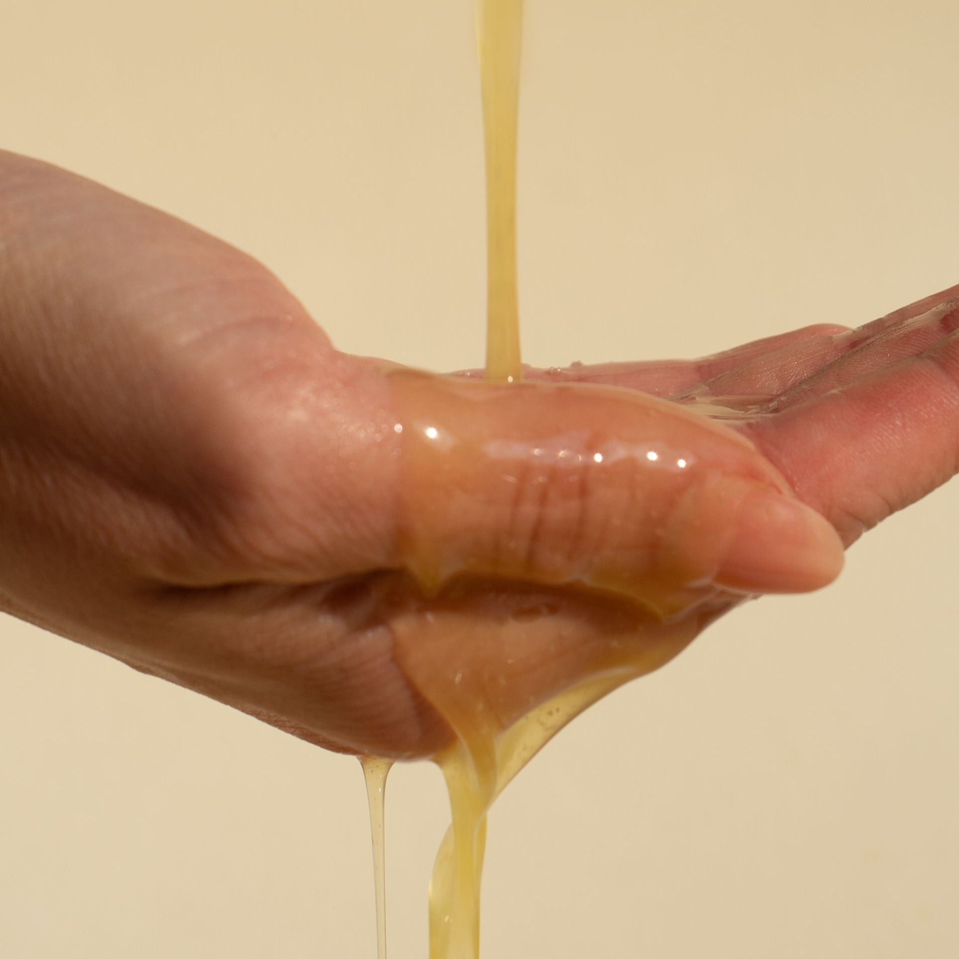 ghee cleansing oil | oil dripping on hand | yinera tallow skincare