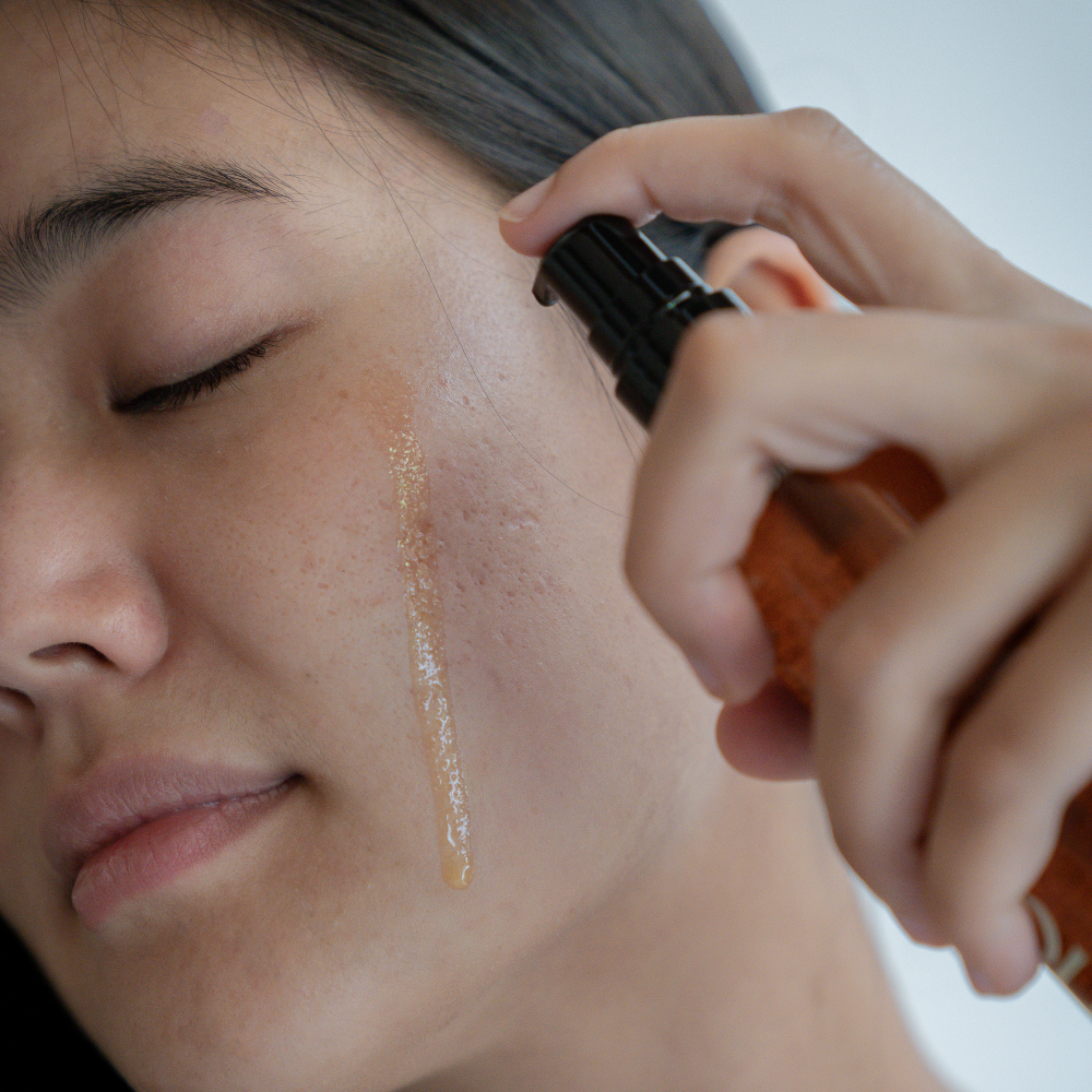 cleansing oil dripping on face yinera skincare
