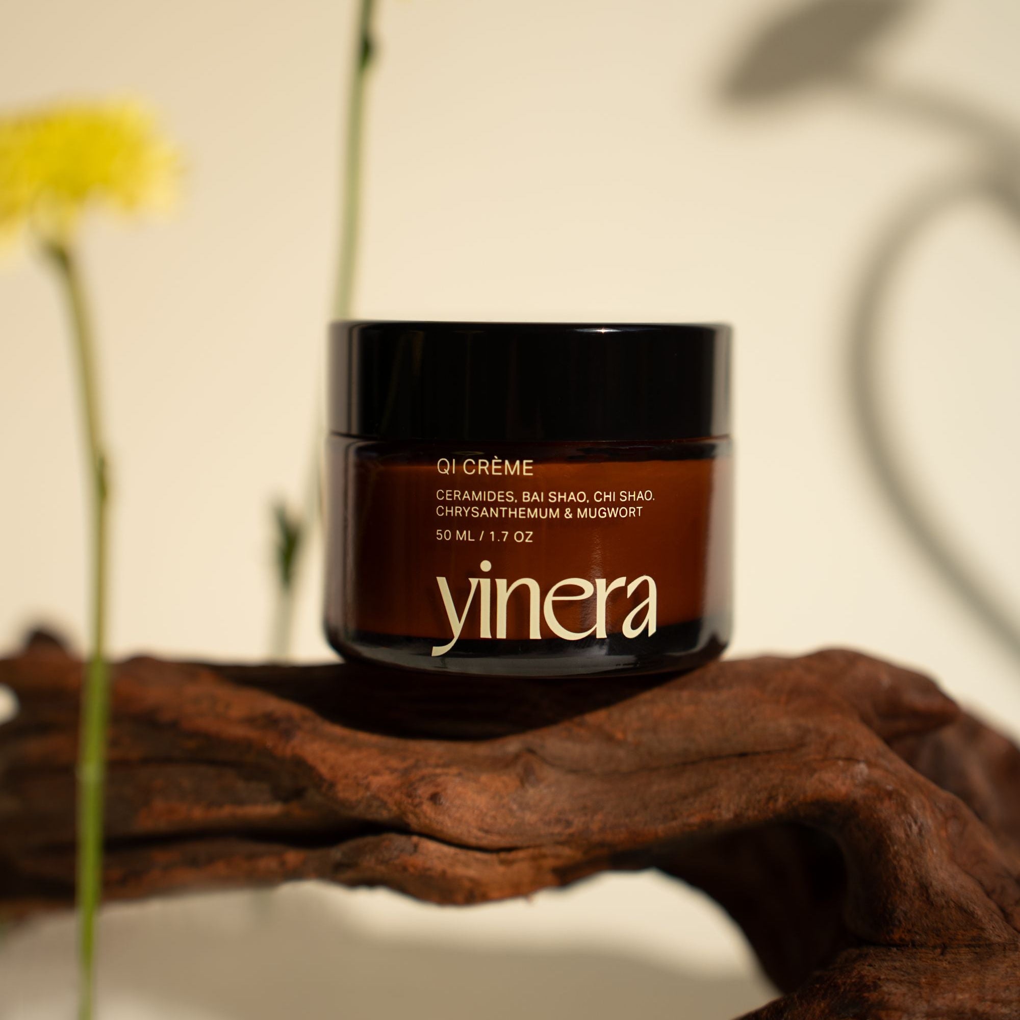 qi tallow cream | yinera tallow skincare | amber bottle on wood
